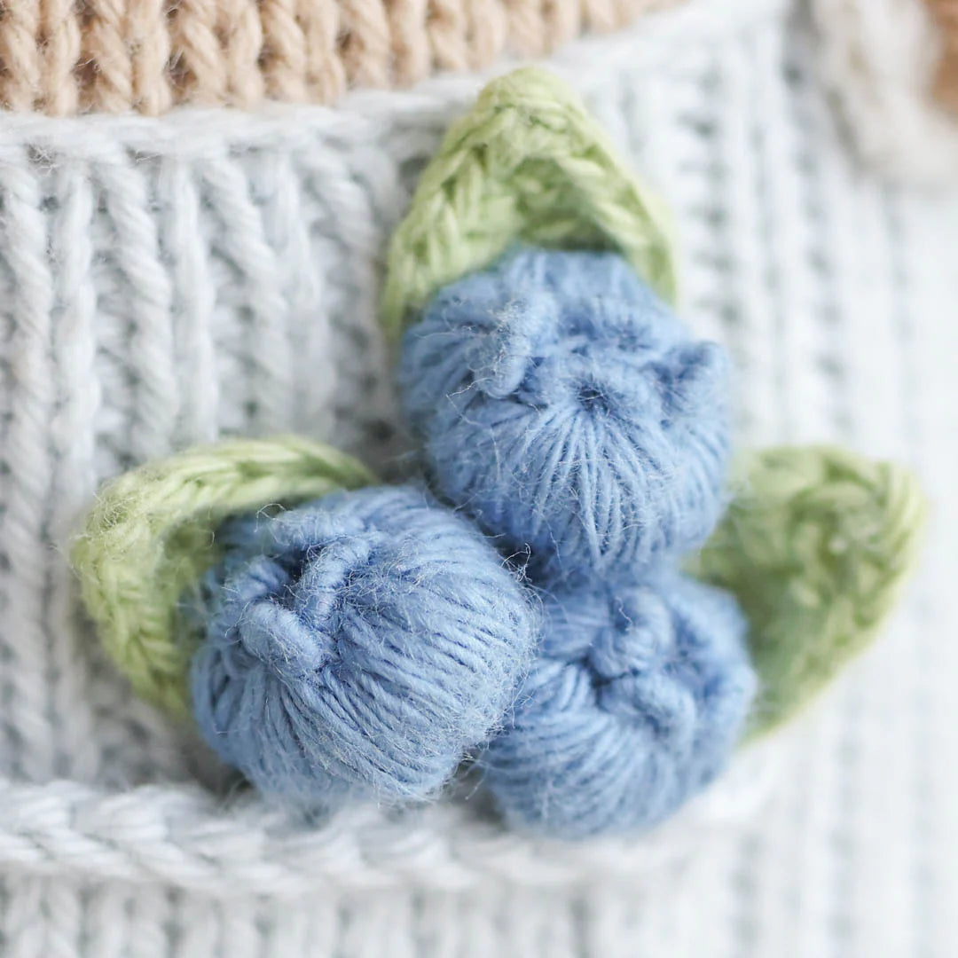 cuddle + kind Hand-Knit Doll - Asher the Cow Blueberry Detail